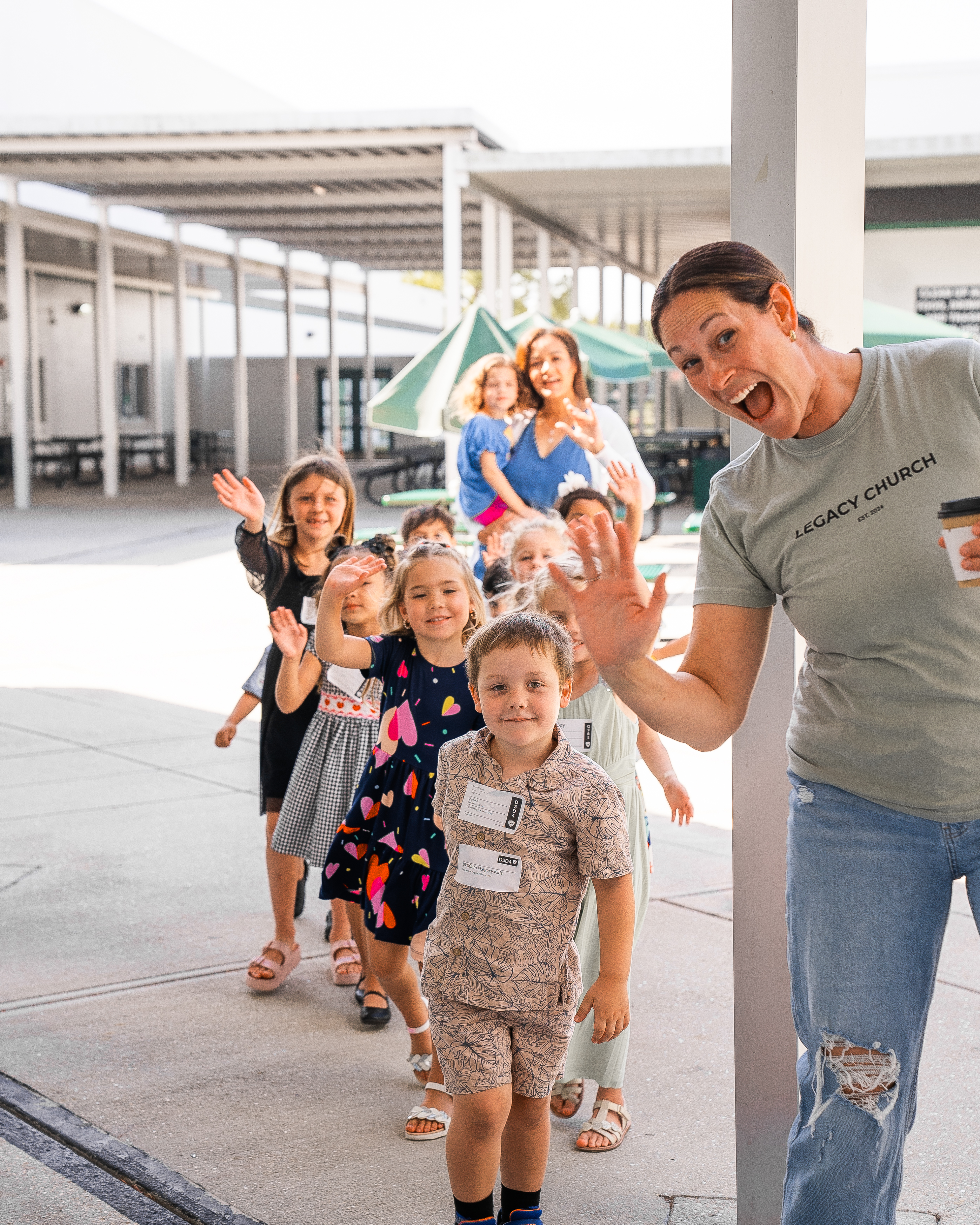Kids walking with Legacy Church volunteer
