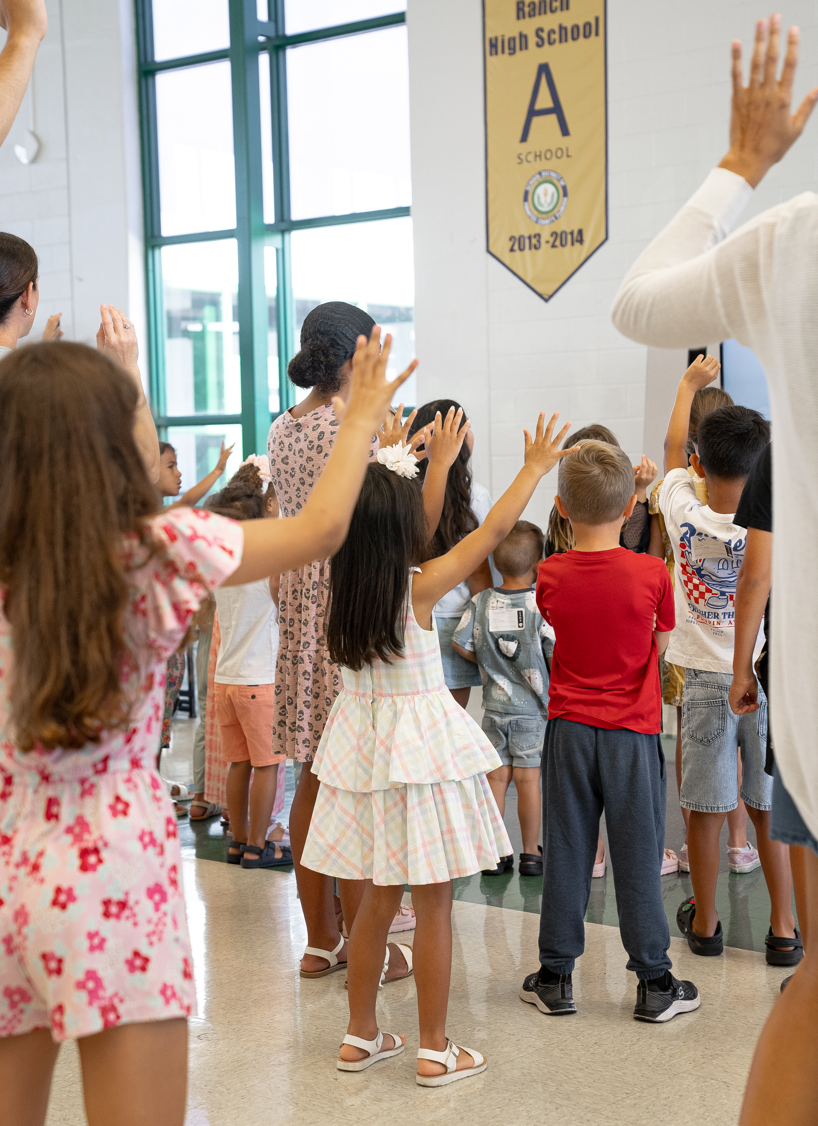 Kids with hands raised in worship at Legacy Church