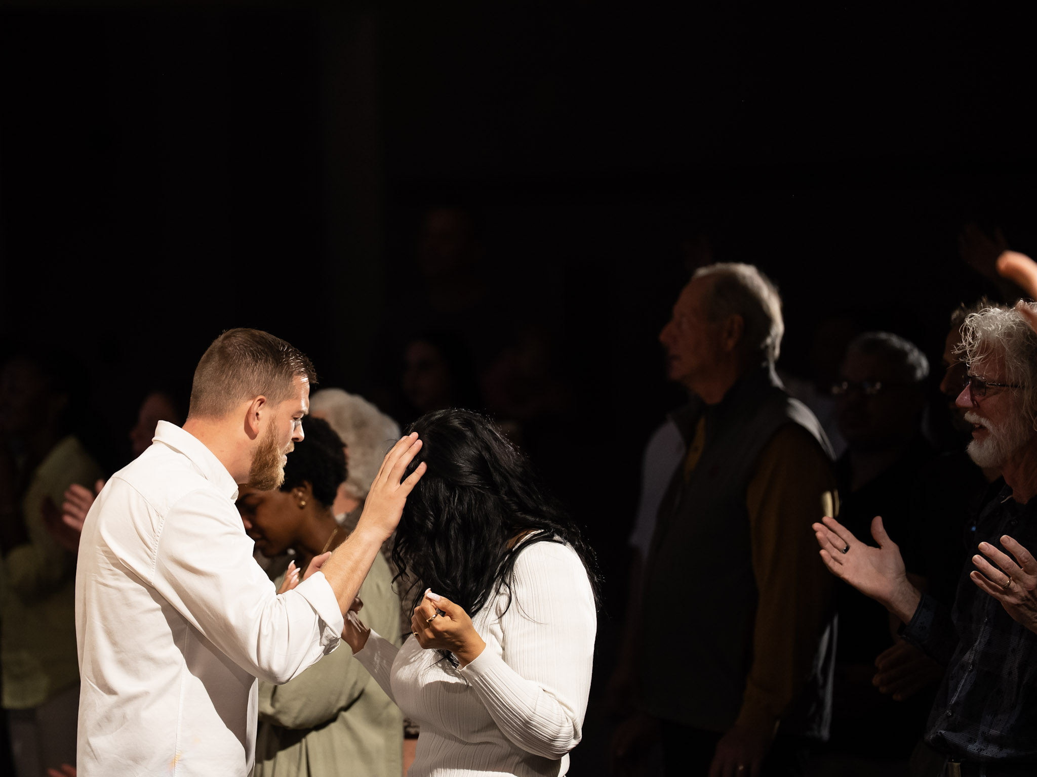 Pastor Chad praying over congregation